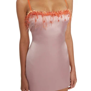 Danielle Guizio Rosa satin klänning med paljettdetaljer - Köptes för 4000kr. Superfin kort rosa klänning i satin med smala orange axelband och unik paljett- och fjäderdrapering längs bysten. Klänningen har figurnära passform och dragkedja i ryggen. Perfekt för dig som vill sticka ut med färg och coola detaljer. 