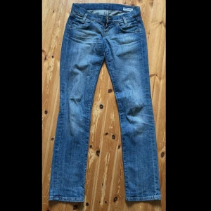 Blåa lågmidjade jeans  - Blåa lågmidjade jeans från Lee. De är raka/utsvändgda i benen. Storlek XS (se midjemått på bild 4 och innerbens längd). De är hela och i fint skick förutom att färgen är lite urtvättad. Hör av er vid frågor. Pris går att diskutera. 