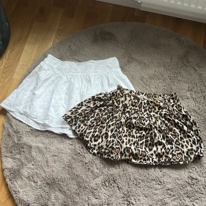 Två kjolar från Gina Tricot - Säljer två kjolar från Gina Tricot i storlek 170. En vit kjol med lätt volang och en leopardmönstrad kjol med resår i midjan. Perfekta för att skapa olika looks och lätta att matcha med olika toppar. 1 för 70 kr eller båda för 115kr aldrig använda 