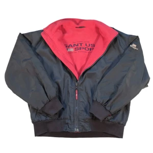 GANT vindjacka VINTAGE ÄKTA - ‼️⚠️PRUTBAR VID SNABB AFFÄR⚠️‼️Snygg  och ÄKTA vindjacka från GANT USA Sport i svart med röd fluffigfleece. PASSAR ÄVEN LARGE PGA STOR STORLEK. Jackan har dragkedja framtill, broderad logga på bröstet och ryggen samt ribbade muddar. Perfekt för dig som gillar klassisk stil. Perfekt för en grisch höst 🍂 🫣Nypris 2399kr🫣 🍀säljer för 1200kr🍀
