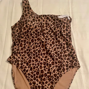 *NY*Leobaddräkt i stl 3xl fr Cubus, presenttips  - U Leo Off S Swimsuit. Ny med lapp. Bara provad. One shoulder baddräkt med vadderade uttagbara kupor. Jag är E/F kupa och de passade mig utan problem, sitter nog bäst på E-G kupa. True to size, dvs passar stl 46. Nypris: 399 sek, Pris nu: 100 sek