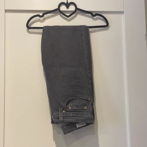 Levi's 501 grå jeans straight fit - Säljer ett par grå Levi's 501 jeans med klassisk straight fit. Jeansen har hög midja, snygga kopparfärgade nitar och ikonisk läderpatch bak. Materialet är robust denim i bomull och färgen är snyggt tvättad grå. Weist 29 length 30