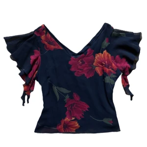 Vintage Blommig blus med volangärm från Hennes - Söt blommig mesh volang topp från gammal h&m. Strl 38 men passar S också. Dragkedja på sidan. 