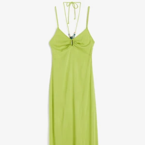 Grön långklänning med smala axelband - Klänningen är oanvänd med prislapp kvar 💗 En grön vadlångklänning i vävd viskositet och figurnära passform. Utskuret parti i fram med pärlklädda knytband som knyts i nacken, pärlorna går att ta bort! Smala reglerbara axelband, ofodrad så perfekt till varma sommardagar! 💚