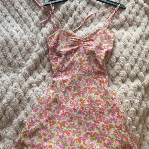 Blommig kort klänning från Gina Tricot - En blommig klänning använd 2-3 gånger köpt 2022-2023 