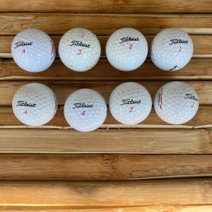 Titleist truffle (8pack) - Bilderna visar ett set med begagnade Titleist truffel golfbollar, perfekta för dig som vill komma igång med golf eller behöver extra bollar till träningen. Bollarna har olika nummer och är i varierande skick, redo för nya rundor på banan.