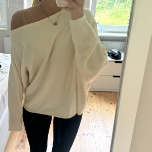Offshoulder ljusbeige tröja - Säljer en supermjuk och oversized ljusbeige tröja med offshoulder-look. Tröjan har långa ärmar och en lös passform som ger en chill vibe. Perfekt att slänga på sig när du vill vara både bekväm och snygg.