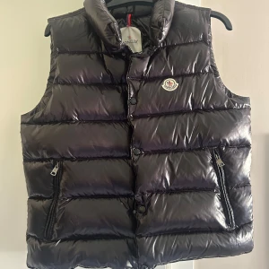 Svart dunväst från Moncler - Snygg svart äkta dunväst från Moncler. Den är i bra skick då den är sparsamt använd. Storlek 2 som motsvarar ungefär M.