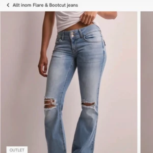 Ljusblå bootcut jeans med slitningar - Snygga ljusblå jeans med bootcut passform och slitna detaljer vid knäna. Jeansen har klassiska fickor fram och bak, samt knapp- och dragkedjestängning. Perfekta för en avslappnad och trendig look.