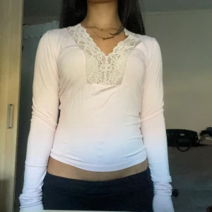Rosa långärmad topp med spetsdetaljer - Säljer en söt rosa långärmad topp från Gina  med v-ringning och spetsdetaljer längs halsringningen. Har sytt lite på öppningen men det går att sprätta upp innan frakt💕😊