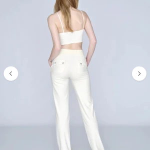 Vita juicy byxor/// SKRIV OM NI VILL HA BILD!!💞 - Säljer ett par vita mjukisbyxor med raka ben och dragsko i midjan. Byxorna har fickor både fram och bak samt en avslappnad passform. Perfekta för en chill och bekväm stil.