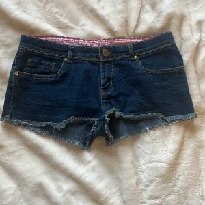Mörkblå jeansshorts low waist - Säljer ett par mörkblå jeansshorts med fransig kant nertill och klassiska fickor både fram och bak. Shortsen har låg midja!. Perfekta för varma dagar! Pris kan diskuteras 🤗 jag har tyvärr ingen bild som jag kan visa på eftersom att de är försmå för mig 