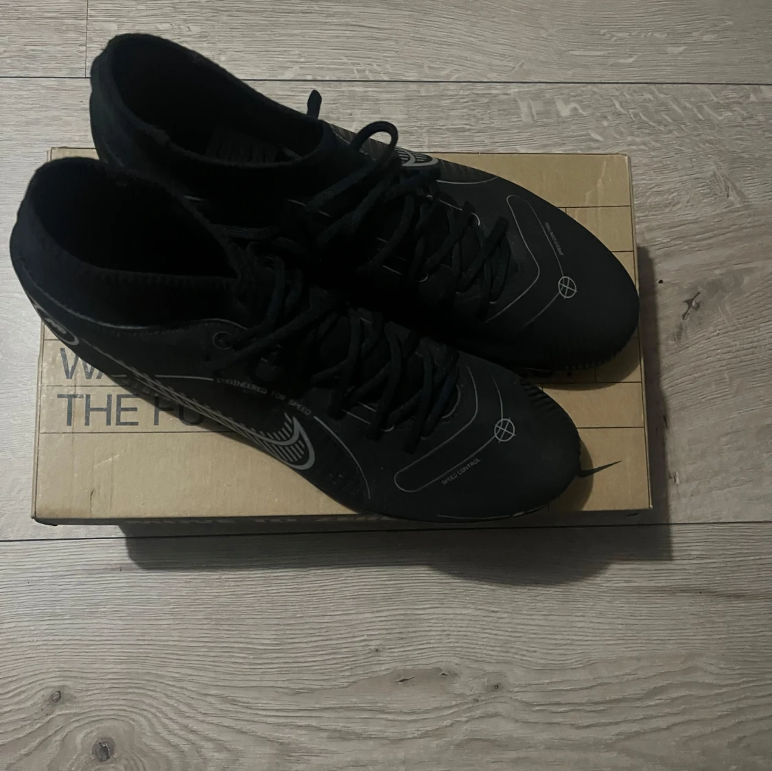 Svarta Nike fotbollsskor med silverdetaljer