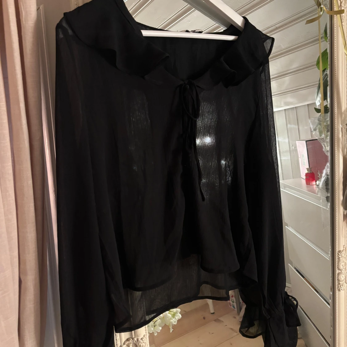 Svart blus med volanger