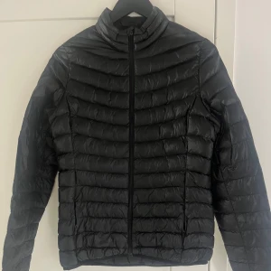 Svart lättviktsjacka från Everest - Snygg svart lättviktsjacka från Everest med dragkedja framtill. Jackan har en quiltad design och långa ärmar, perfekt vårjacka. Fint skick! Sparsamt använd. Lite figursydd.