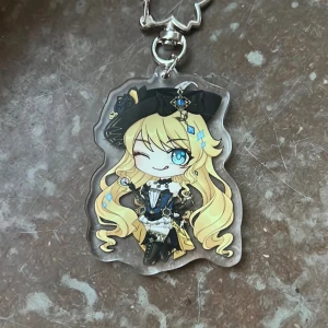 Genshin Impact Navia keychain - Keychain of Navia from Genshin Impact! Perfect for your bag decorations or collection :)  (There might be scratches on the surface but that’s only on the protective layer of plastic, peel it off on both sides and it’ll be perfectly shiny!)