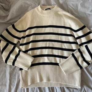 Randig stickad tröja - Säljer en stilren och bekväm randig tröja i beige och svart. Tröjan är stickad med långa ärmar💕