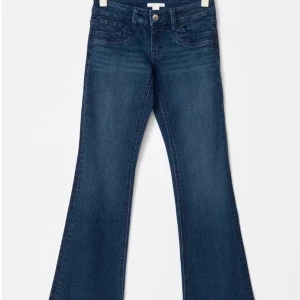 Blå bootcut jeans low waist  - Snygga blå bootcut jeans med klassisk femficksdesign och knappgylf. Perfekta för en avslappnad stil med en touch av retro. Passar bra till både sneakers och klackar. Low Waist! Använd 1 gång så helt nya, storlek 170 i Gina Young men passar mig som har s och är 170 lång 