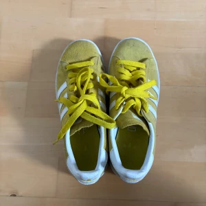 Gula Adidas Campus sneakers - Säljer ett par gula Adidas Campus sneakers  med vita detaljer och klassiska tre ränder på sidan🌸