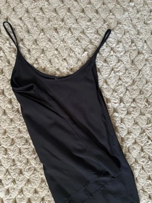 Svart linnetopp från Vero Moda XS - Säljer en svart linnetopp från Vero Moda i storlek XS. Toppen har tunna axelband och en enkel, rak passform. Materialet är mjukt och lätt, perfekt för varma dagar. Stilren och enkel design som funkar till många olika outfits.
