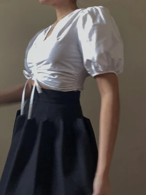 Vintage Bottega Veneta Wool Skirt - Vintage 2000s Bottega Veneta Black Felt Wool Skirt with structural pleating. Best worn high waisted. Fully lined with zip closure. Excellent Condition. 80% Wool 20% Nylon Made in Italy. Original Tagged Size 38.Model is 160cm (5"3) and generally fits S/M.  74 CM/ 29.1 IN Length 64 CM/ 25.2 IN Waist 72 CM/ 28.3 IN Hips 