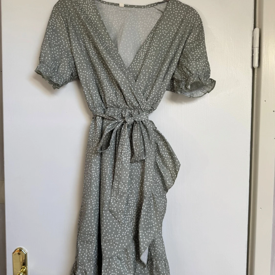 Grön prickig omlottklänning med volang