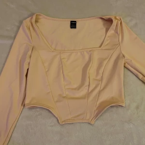 Långärmad topp  - Säljer en långärmad topp från Shein i färgen aprikos, storlek XS/34. Toppen har väldigt fina detaljer och sitter jättefint på.🩷