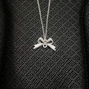 Silver Bowtie Pendant - Minimalist stainless steel necklace with a sleek bowtie pendant (1 × 2 cm). Chain length: 50 cm. Rust- and nickel-free