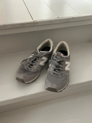 Newbalance sneakers - Gråa New Balance modell 996. Lite fläckar, kanske går att få bort har inte försökt 🤷‍♀️ Man tänker inte på dom när man har skorna på sig. Förutom fläckarna är skorna i väldigt bra skick, har knappt använt dom. Ganska små i storleken.
