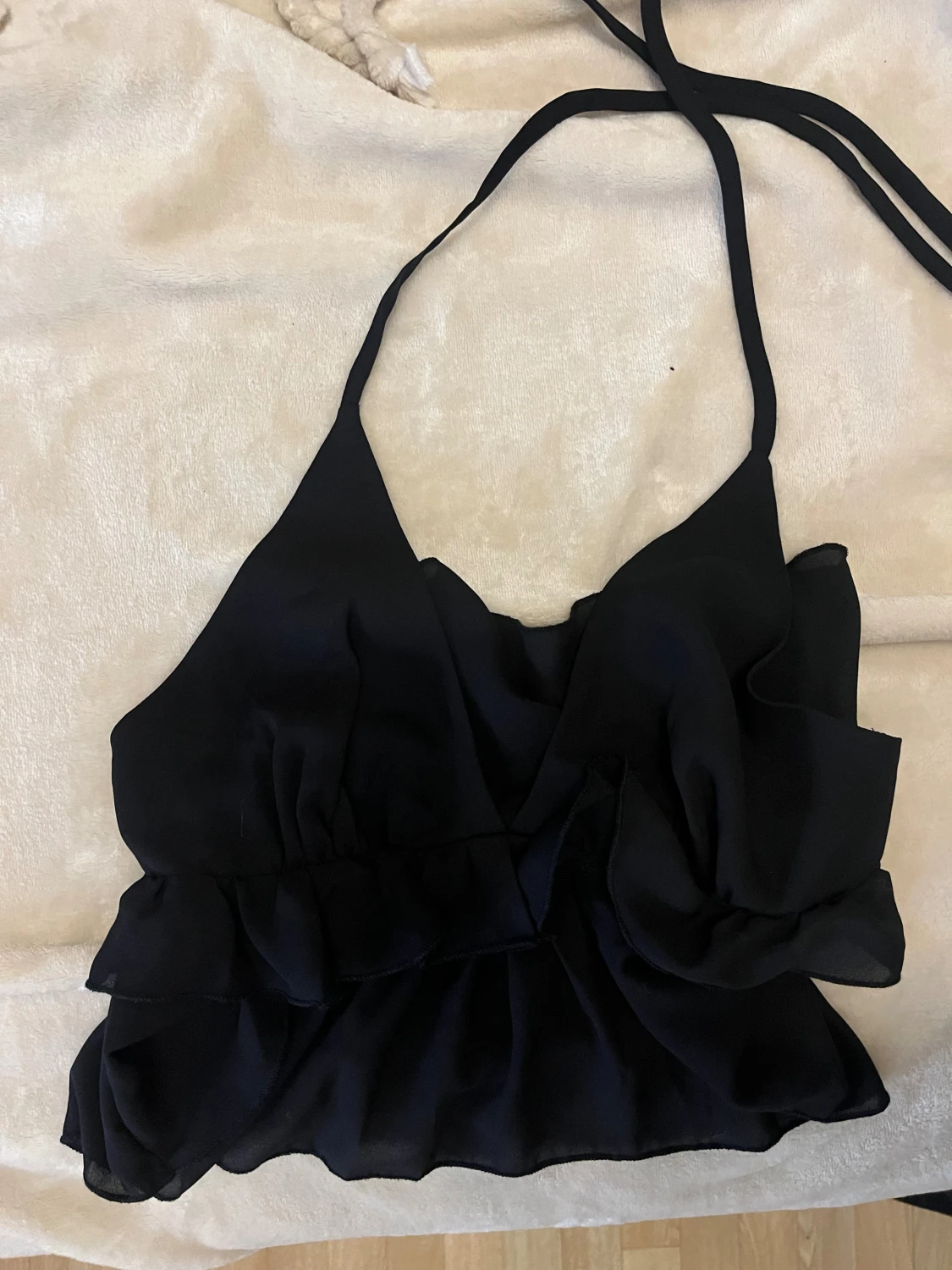 Svart omlott linnetopp med volanger