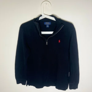 Svart half zip tröja från Polo Ralph Lauren - Svart långärmad tröja från Polo Ralph Lauren med röd broderad logga på bröstet. Tröjan är i bra skick och redo för nytt liv                                                    Frågor/funderingar hör av dig 🤙🏽 