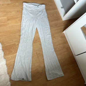 Ljusgrå mjukisbyxor från 157 - Superbekväma ljusgrå mjukisbyxor från 157 med hög midja och utsvängda ben. Tillverkade i mjukt bomullsmaterial som känns skönt mot huden. Perfekta för chill dagar eller när du vill ha en avslappnad look.