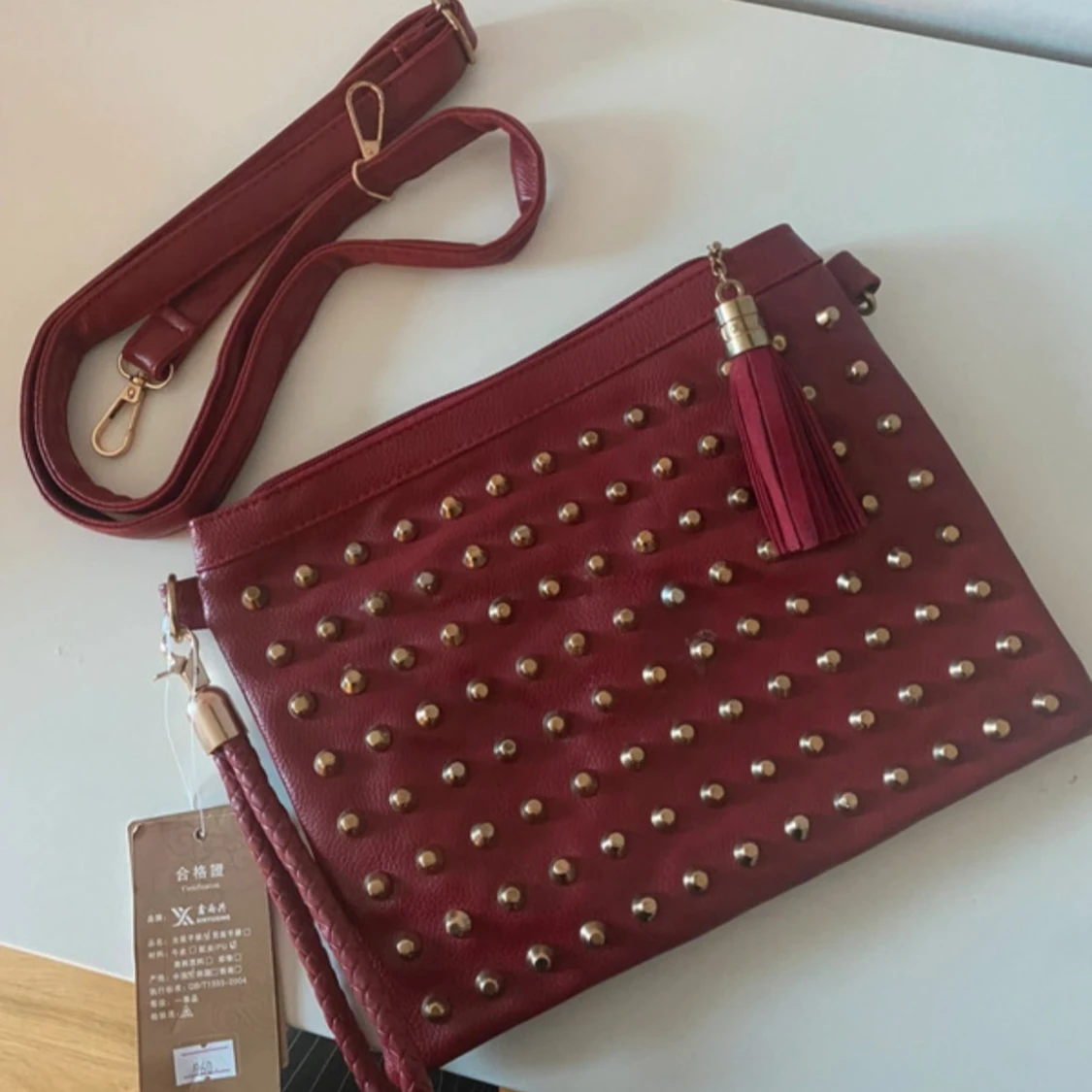 Röd kuvertväska med nitar och tofs - 1