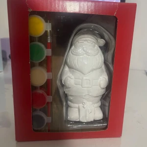 Tomte att måla själv - Produkten på bilden är ett målarset med en tomtefigur i gips och tillhörande färger. Setet är för kreativt pyssel och innehåller pensel samt fem färger. Förpackningen har mindre slitage i hörnen men innehållet ser helt och oanvänt ut.