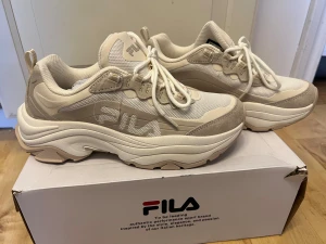 Beige chunky sneakers från FILA - Säljer ett par beige chunky sneakers från FILA med plattformssula och rund tå. 