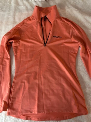 Orange träningströja  - Tränings tröja från craft med halv dragskedja