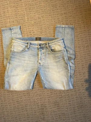 Neuw ljusblå jeans - Säljer ett par ljusblå jeans från Neuw i modellen Lou Slim. Jeansen har klassisk femficksdesign, smal passform och snygga detaljer. Materialet är jeans med en mjuk känsla och de har en modern look med raka ben och normal midja.