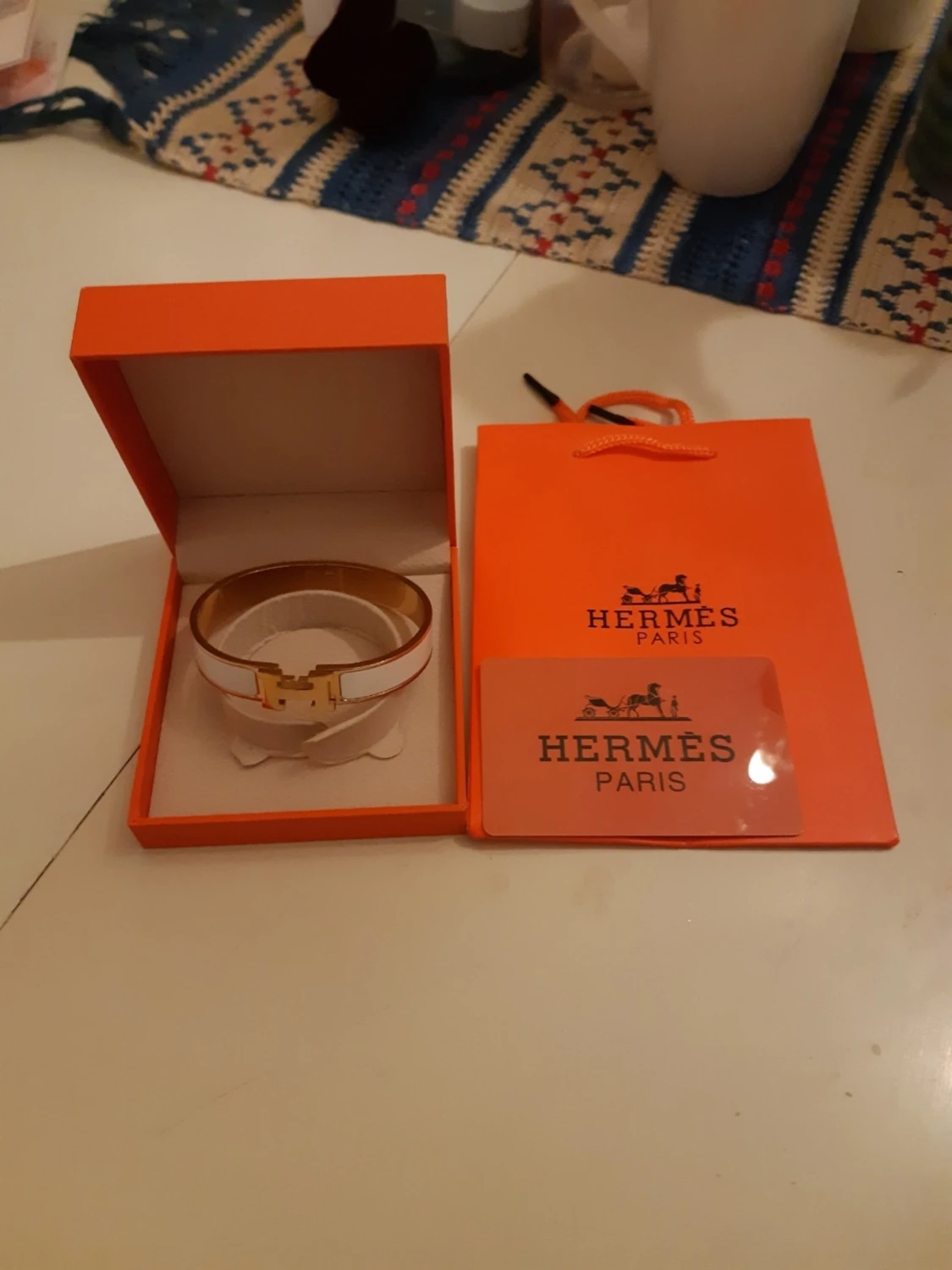 Vitt Hermès armband med gulddetaljer