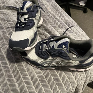 ASICS sneakers vit/marinblå/grå (EU 45) - Snygga och bekväma ASICS i klassisk färgkombination! Passar perfekt till både vardags- och träningsoutfits. Aldrig använda – i helt nytt skick           Original förpackning finns ej!