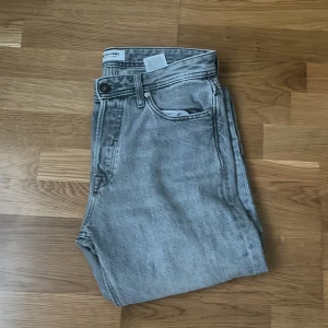 Grå jeans från Jack & Jones -  Hej! Säljer mina gråa jack and Jones jeans. De är använda en del men i väldigt bra skick.  Storlek:30 midja 34 längd. Modellen är raka.  Skriv för fler mått eller vid funderingar!