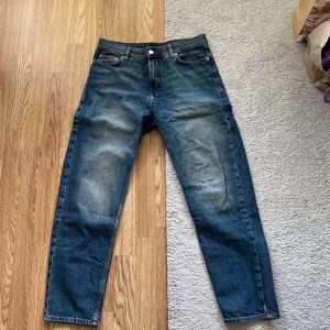 Blå jeans från Sweet SKTBS, Small - Säljer ett par klassiska blå jeans från Sweet SKTBS köpta på JunkYard i storlek Small. Jeansen har en rak passform med normal midja och snygga slitningar framtill. Tillverkade i bomull och perfekta för dig som gillar en enkel och stilren look.