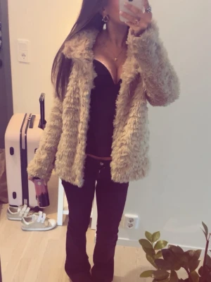 Beige fluffig pälsjacka - Säljer en supermjuk och fluffig beige pälsjacka med bred krage. Jackan har en loose passform och är perfekt för dig som vill sticka ut med en mysig och trendig look. Passar perfekt till både jeans och klänning. Snygg och varm för kyligare dagar! använder inte längre, pris går att diskutera, köpt här på plick för några månader sedan, väldigt varm och skön 