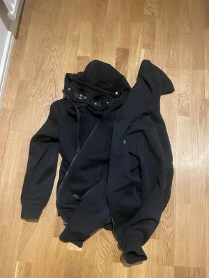 Svart hoodiejacka med glasögon i huvan - Två hoodies till byte