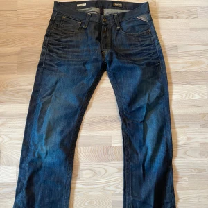 Mörkblå Replay jeans W34 L36 - Snygga mörkblå jeans från Replay med klassisk femficksdesign och raka ben. Jeansen har kontrastsömmar och detaljerad backficka. Dom är croppade (inte av mig) och är därför kortare och passar mer 32-34 i längd