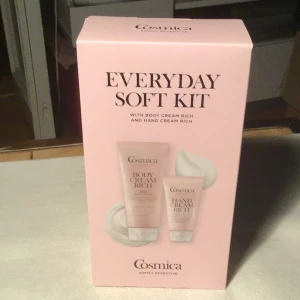 Cosmica Everyday Soft Kit - Säljer ett rosa Everyday Soft Kit från Cosmica med Body Cream Rich (200 ml) och Hand Cream Rich (75 ml). Båda produkterna kommer i tuber och är mildt parfymerade, perfekta för att ge huden extra fukt och mjukhet. Snygg förpackning som passar bra som present.