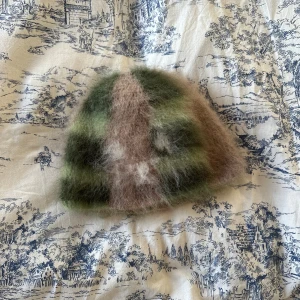 mohair beanie - made by me, features a very subtle little: ʕ •ᴥ•ʔ  the price is fixed, i work with a total of 10 balls of yarn simultaneously(for each color i have three balls of yarn, except for the white)and they arent cheap and it takes quite a few hours to make, hope you understand c: