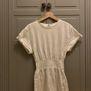 Vit klänning från H&M - Vit klänning som går lite över knäna. Tight i midjan och stora ärmar, Från H&M