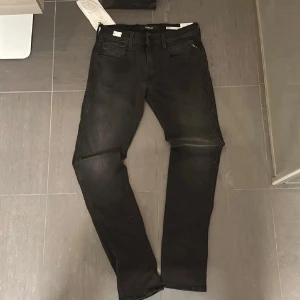 Replay Anbass hyperflex  - Helt nya,Svarta Replay Anbass jeans med snygg tvättad look och klassiska fem fickor. Slimmad passform och raka ben, med Replay-logga på fickan och bakfickor med broderad detalj. Perfekta för dig som gillar stilrena och moderna jeans.
