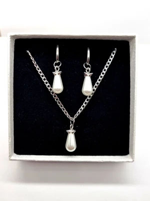 Stilrena örhängen och halsband  - Stilrena örhängen och halsband inspirerade av Maria Nilsdotter. Material-rostfritt stål. Örhängen längd-3,7cm, halsband längd-40cm. ☝️Vid köp ingår två extra berlocker som kan bytas ut, då själva hänget är ömtåligt och känsligt för stötar.