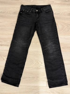 Svarta raka jeans - Klassiska svarta jeans med rak passform och fickor. Jeansen är tillverkade i slitstarkt bomullsdenim. Perfekta för dig som gillar en tidlös och avslappnad stil.